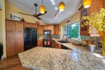 The kitchen with ample granite counterspace, beautiful lighting and a view of the mountains is perfect for whipping up a gourmet meal.